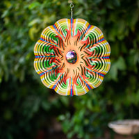 Sun wind spinner hanging in a green garden
